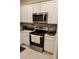 Kitchen featuring stainless steel appliances, white cabinets, and tile backsplash at 4762 Sparkling Shell Ave, Kissimmee, FL 34746
