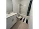 Bright bathroom with modern vanity, toilet, bathtub, and shower at 5006 Vellacito Way, Davenport, FL 33897