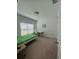 Bright bedroom with a large window, desk, and neutral-colored carpet at 5006 Vellacito Way, Davenport, FL 33897