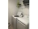 Bright laundry room featuring modern washing machine and dryer and wire shelving at 5006 Vellacito Way, Davenport, FL 33897