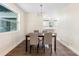 Dining room with a modern chandelier, wood-look flooring, and view into the kitchen at 577 Compton Ct, Deland, FL 32724
