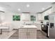 Bright kitchen features white cabinets, stainless steel appliances, and a functional center island at 577 Compton Ct, Deland, FL 32724