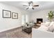 Cozy living room with white brick fireplace, ceiling fan, and French doors leading to the outside at 577 Compton Ct, Deland, FL 32724