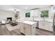 Open-concept kitchen and living space with an island, stainless steel appliances, and fireplace at 577 Compton Ct, Deland, FL 32724
