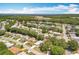 Beautiful aerial view showcasing the neighborhood's landscape, with lush trees and blue skies at 6042 Wade St, Leesburg, FL 34748