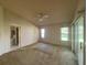 Spacious main bedroom with a ceiling fan and large windows at 6042 Wade St, Leesburg, FL 34748