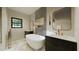 Modern bathroom features a freestanding tub, double vanity, and elegant fixtures, and a patterned accent wall at 6168 Sw 154Th St, Ocala, FL 34473