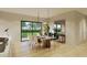 Sunlit dining room featuring a large table for eight and a large window overlooking the backyard at 6168 Sw 154Th St, Ocala, FL 34473