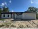 Charming single-story home featuring a modern exterior and an attached two-car garage at 6168 Sw 154Th St, Ocala, FL 34473