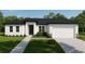 Charming single-story home featuring a modern exterior, well-manicured lawn, and attached two-car garage at 6168 Sw 154Th St, Ocala, FL 34473
