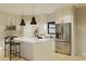Modern kitchen boasts an island with seating, stainless steel appliances, and white cabinets at 6168 Sw 154Th St, Ocala, FL 34473
