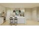 Bright modern kitchen featuring an island with seating, stainless steel appliances, and white cabinetry at 6168 Sw 154Th St, Ocala, FL 34473