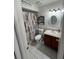 Well-lit bathroom with modern sink, decorative mirror, and shower at 68 S Marbrisa Way, Kissimmee, FL 34743