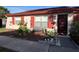 Charming single-story home featuring a cozy front bench, red shutters, and well-maintained landscaping at 68 S Marbrisa Way, Kissimmee, FL 34743