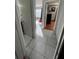 Hallway featuring white tile flooring, doorways to rooms and natural light at 68 S Marbrisa Way, Kissimmee, FL 34743