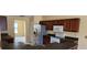 View of the Kitchen with stainless steel appliances, dark countertops, and raised breakfast bar at 697 Winding Lake Dr, Clermont, FL 34711