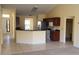 Bright kitchen featuring tiled floors, stainless appliances and a breakfast bar overlooking the living area at 697 Winding Lake Dr, Clermont, FL 34711