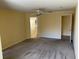 Spacious main bedroom with carpeted floors, ceiling fan and access to the main bathroom at 697 Winding Lake Dr, Clermont, FL 34711