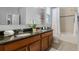 Bathroom with dual sinks, granite countertops, and a shower-tub combo at 721 Lake Cove Pointe Cir, Winter Garden, FL 34787