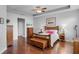 Spacious bedroom features wood floors, tray ceiling, ceiling fan, and furnishings at 721 Lake Cove Pointe Cir, Winter Garden, FL 34787