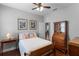 Comfortable bedroom with hardwood floors, ceiling fan, and natural light at 721 Lake Cove Pointe Cir, Winter Garden, FL 34787