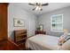 Comfortable bedroom featuring a ceiling fan, a window, and wood furniture at 721 Lake Cove Pointe Cir, Winter Garden, FL 34787