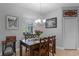 Cozy dining area featuring a dark wood table set, chandelier lighting, and natural light from the window at 721 Lake Cove Pointe Cir, Winter Garden, FL 34787