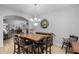 This cozy dining room features tile floors, a wooden table, and a decorative chandelier at 721 Lake Cove Pointe Cir, Winter Garden, FL 34787