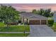 Charming single-story home featuring an attached 3-car garage, manicured lawn, and inviting front entrance at 721 Lake Cove Pointe Cir, Winter Garden, FL 34787