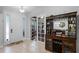 Inviting foyer with tile flooring, bar, and decorative glass door for natural light at 721 Lake Cove Pointe Cir, Winter Garden, FL 34787