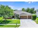 Well maintained single story home featuring a 3-car garage and manicured lawn at 721 Lake Cove Pointe Cir, Winter Garden, FL 34787