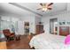Spacious main bedroom with ceiling fan, sitting area and a doorway leading to the kitchen at 721 Lake Cove Pointe Cir, Winter Garden, FL 34787