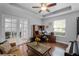 Inviting office space features hardwood floors, a ceiling fan, and abundant natural light at 721 Lake Cove Pointe Cir, Winter Garden, FL 34787