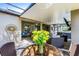 Covered patio with dining table and seating, living area with fireplace, and relaxing hot tub at 721 Lake Cove Pointe Cir, Winter Garden, FL 34787