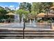 Inviting water park features covered benches and a splash pad area surrounded by lush landscaping at 721 Lake Cove Pointe Cir, Winter Garden, FL 34787