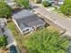 An elevated view of the house showing its architectural design, fencing, landscaping, and neighborhood context at 730 W Swoope Ave, Winter Park, FL 32789