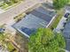 A bird's-eye view of the home, showcasing the roof design, driveway, yard, and surrounding area at 730 W Swoope Ave, Winter Park, FL 32789