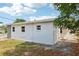 A spacious backyard with minimal grass and a white home exterior at 730 W Swoope Ave, Winter Park, FL 32789