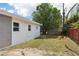 Backyard features a white house, shed, trees, and patchy grass at 730 W Swoope Ave, Winter Park, FL 32789