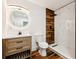 Modern bathroom featuring a wood vanity, stylish mirror, and a beautifully tiled shower at 730 W Swoope Ave, Winter Park, FL 32789