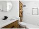 Modern bathroom with shower, beautiful vanity, modern toilet, wood tile, and black shower hardware at 730 W Swoope Ave, Winter Park, FL 32789