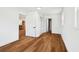 Open bedroom with hardwood floors leads to kitchen, bathroom, and hallway at 730 W Swoope Ave, Winter Park, FL 32789
