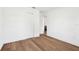 Bright bedroom features wood-look floors, white walls and trim, a closet, a door, and natural light at 730 W Swoope Ave, Winter Park, FL 32789