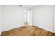 Bedroom features wood-look floors, white walls and trim, a closet, a door, and natural light at 730 W Swoope Ave, Winter Park, FL 32789