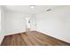 Bedroom features wood-look floors, white walls and trim, a door, and natural light at 730 W Swoope Ave, Winter Park, FL 32789