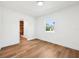 Bright bedroom with hardwood floors, white walls, and a window bringing in natural light at 730 W Swoope Ave, Winter Park, FL 32789