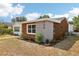 Picture of the corner of a modern single story home with a wood exterior and a view of the yard at 730 W Swoope Ave, Winter Park, FL 32789