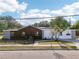 A rear view of the property showcasing distinct architectural styles and large windows for ample natural light at 730 W Swoope Ave, Winter Park, FL 32789
