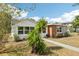 A well maintained lawn with a small tree in the front yard, compliments a modern single story home at 730 W Swoope Ave, Winter Park, FL 32789