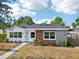 Charming single-story home featuring a mix of modern materials and professionally landscaped yard at 730 W Swoope Ave, Winter Park, FL 32789